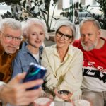 A group of senior friends capture a cheerful selfie indoors, enjoying quality time together.